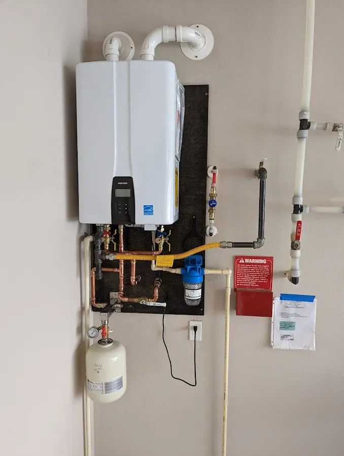 Professional plumber installing copper piping in a Salem home